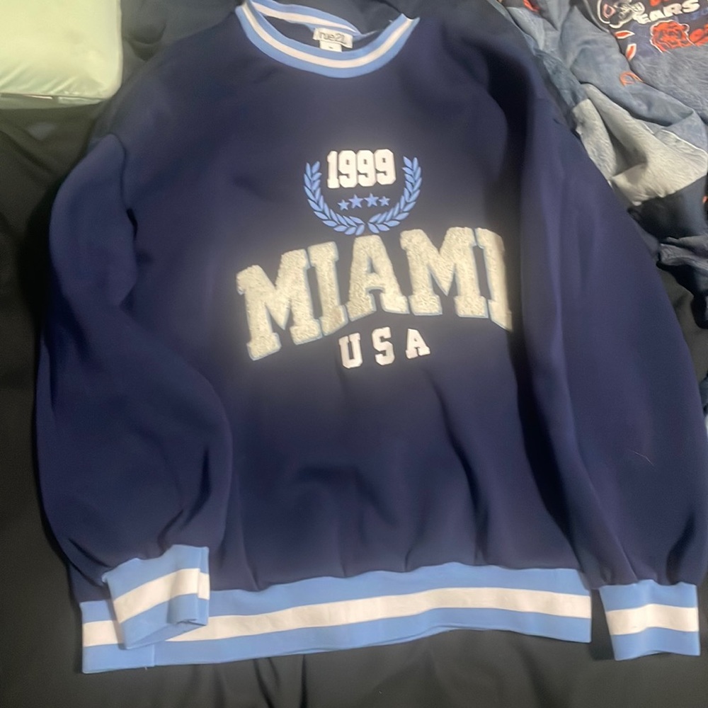 Sweater with riding on it